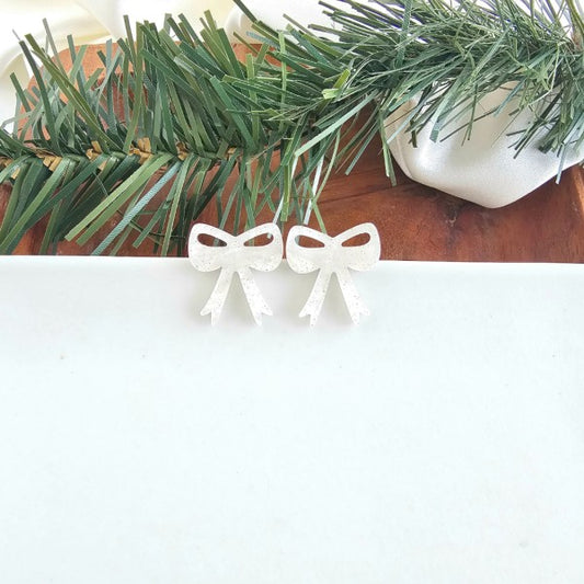 White Shimmer OneSize White Christmas Bow Stud Earrings | Trendy Earrings Outfit Idea for Women by Ro + Ivy | Elevated Basics, Modern Comfort & Style